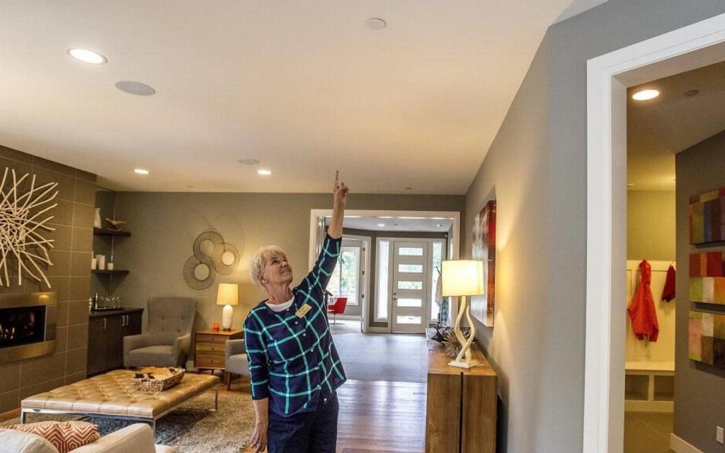A woman pointing at home fire sprinklers.