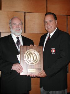 NFSA Aus Marburger presents the Golden Sprinkler Award to then-NFSA President, John Viniello in 2005.